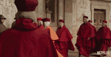 priest red robe looking up walking by walking towards