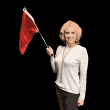 Blonde woman waving a red flag