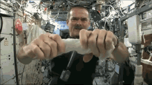 Wringing A Cloth In Space GIF - Wringing Wet Cloth GIFs