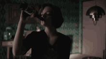 the queens gambit tv show anya taylor joy drinking a bottle of alcohol beth harmon