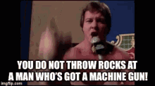 Do Not Throw Rocks At A Man Whos Got A Machine Gun GIF - Do Not Throw Rocks At A Man Whos Got A Machine Gun Rowdy Roddy Piper GIFs