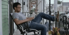 Lounging With Book In Hand GIF - Lounging Lounging With A Book Rocking Chair GIFs
