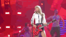 taylor swift rocking out guitar red tour
