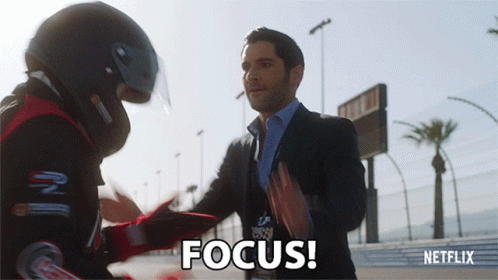 Gif of Lucifer from the TV show Lucifer slapping a race car driver and saying 'Focus!'
