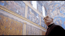 pope francis jonathan pryce looking paintings art