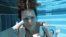 applying concealer underwater waterproof makeup elf swimming nose plug