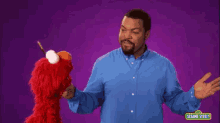 Ice Cube On Sesame Street GIF - Elmo Icecube Ice GIFs