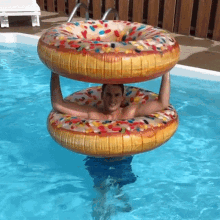 Throwing An Inflatable Donut Floater Anthony Alfredo GIF - Throwing An Inflatable Donut Floater Anthony Alfredo Take This GIFs