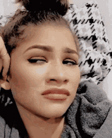 Gif of Zendaya, a light skinned Black woman with her hair up in a bun, rolling her eyes and giving a side eye while looking off to the left