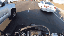 driving in between two cars motorcyclist motorcyclist magazine on a road trip overtaking car