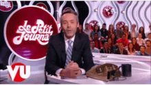 tv show le petit journal man talking suit