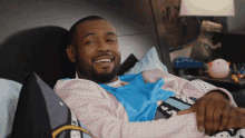 Laughing Bed GIF - Laughing Bed Isaiah Mustafa GIFs