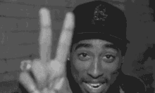 2pac outlaw peace sign smiles