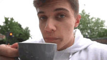 Sipping Hot Beverage Sip Up GIF - Sipping Hot Beverage Sip Up Outdoors GIFs