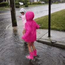 kids jumping raining muddy puddles