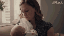 hold baby robyn anna paquin flack looking at baby