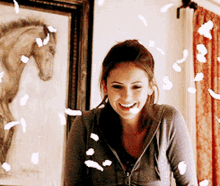 Elena Gilbert Feathers Floating Around Her In A Spell GIF - Elena Gilbert Feathers Floating Around Her In A Spell The Vampires Diaries GIFs