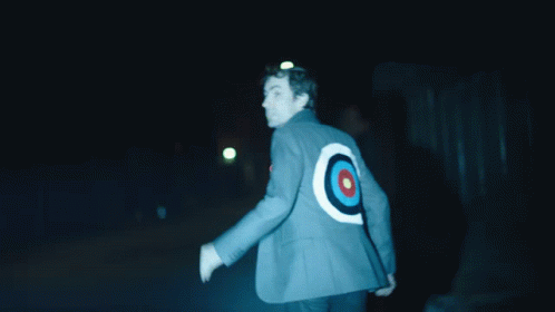Person with a target on their back walking at night