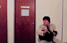 Jackie Chan Dragons Forever GIF - Jackie Chan Dragons Forever Briefcase GIFs
