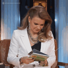 Reading A Book Michele Romanow GIF - Reading A Book Michele Romanow Dragons Den GIFs