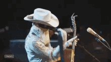 Put On A Guitar Orville Peck GIF - Put On A Guitar Orville Peck Stagecoach GIFs