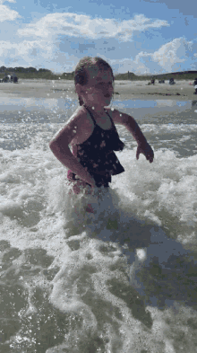 little girl swimming beach pose swimsuit