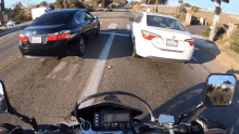 driving in between two cars motorcyclist motorcyclist magazine muddling through two cars overtake