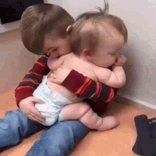 Baby On Lap Sibling Love GIF - Baby On Lap Sibling Love Cute Baby GIFs
