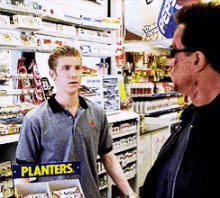 Arnie Scaring The Poor Cashier GIF - Arnie Arnold Schwarzenegger Cashier GIFs