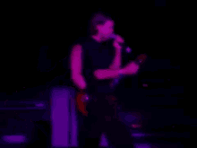 performing live concert on stage playing guitar performing live concert on stage playing guitar
