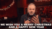 We Wish You A Merry Christmas And A Happy New Year Neil Diamond GIF - We Wish You A Merry Christmas And A Happy New Year Neil Diamond Christmas Medley Song GIFs