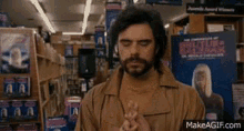 jemaine clement playing tiny piano gif