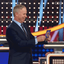 Smiling Family Feud Canada GIF - Smiling Family Feud Canada Looking At The Card GIFs