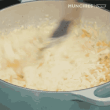 stirring cooking grits cheesy yummy