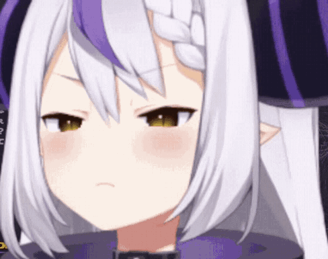 A GIF of Laplus Darkness from Hololive making a serious face and then smiling