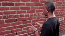 guy talking to brick wall fast talking alone talking to self