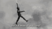 hes a man of mystery an enigma hes a man of secret flying swinging through air