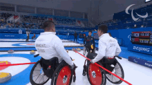 Raised Fist China GIF - Raised Fist China Mixed Wheelchair Curling GIFs