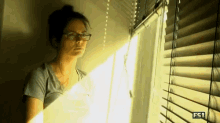 Katie Nolan Waiting GIF - Katie Nolan Waiting Window Blinds GIFs