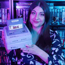 showing satellaview lady decade showing a gaming product showcasing gaming console