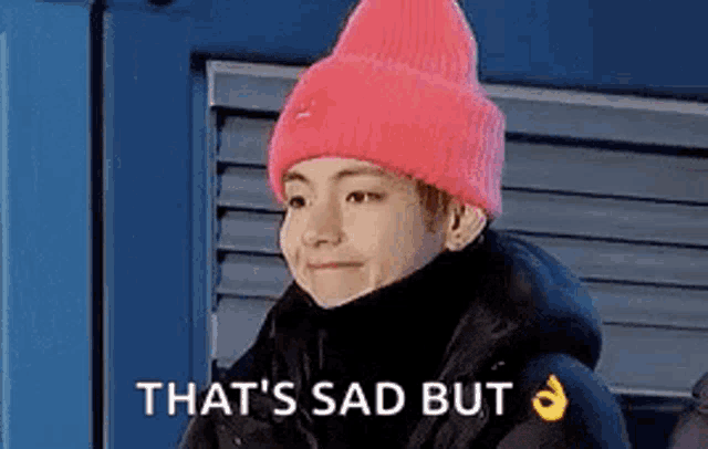 BTS V grimacing with caption 'it's sad but okay hand emoji'