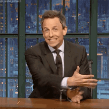 hand gesture presenting welcome smiling seth meyers