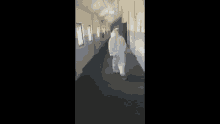 walking hazmat white suit hall way