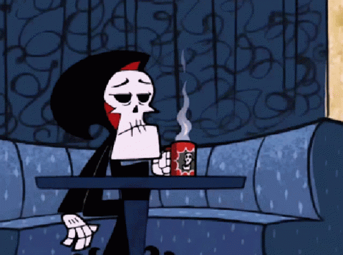 grim with hot coffe on couch
