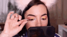 putting fake eyelashes bilintina bilintina makeup eye makeup looking into mirror