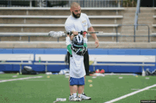 Lacrosse Coach Lifts Up Kid Holding Lacrosse Stick GIF - Lacrosse Lacrosse Camp Strong GIFs