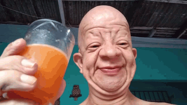Bald Guy Drinks Orange Juice GIF - Bald Guy Drinks Orange Juice GIFs